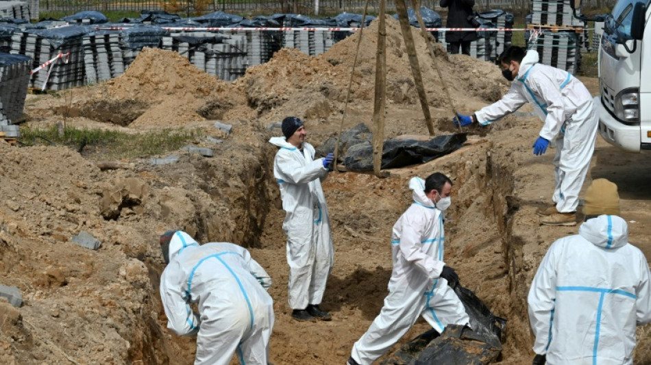 French police officers probe Bucha mass grave