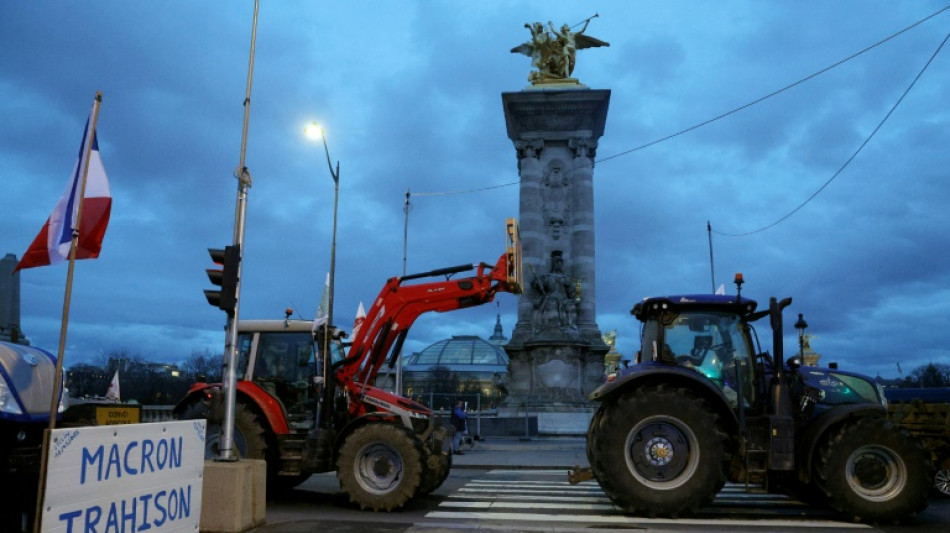 Fuming French farmers camp out in Paris despite government pledges